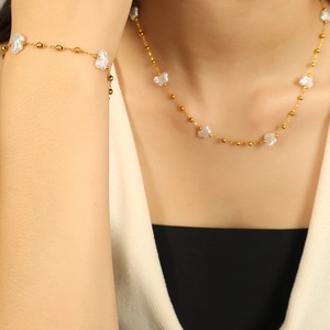 Irregular pearl jewelry set with 18k gold plated necklace and bracelet on a model