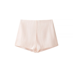 Detailed view of pale pink satin shorts featuring pleated design and silky texture fabric