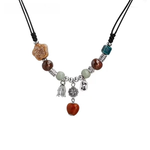 Ethnic ceramic heart beaded necklace with floral charms and silver bell pendant