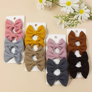 Handmade waffle texture bow hair clips in 16 assorted colors on display card