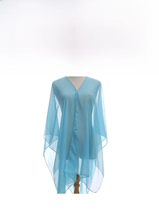 Detail view of a loose blue chiffon shawl with pearl buckle decoration on a model