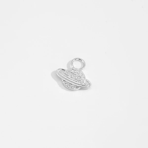 Macro shot of silver planet pendant with inlaid cubic zirconia and a round hanging ring