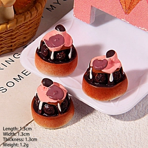 Detailed macro view of 1.3cm miniature resin chocolate cake with pink cream topping