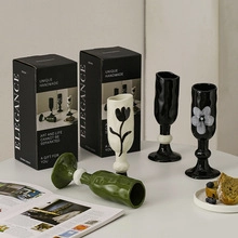 Close-up of unique handmade ceramic cups with elegant floral patterns and gift packaging