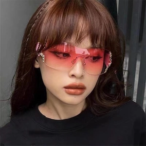 Detail of Y2K rimless sunglasses with pink gradient lenses and rhinestone accents