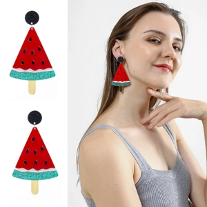 Detail of acrylic watermelon popsicle earrings with red finish and green glitter