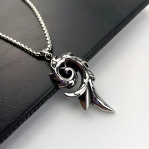 Detailed macro view of a silver square pendant featuring an intricate swirl pattern