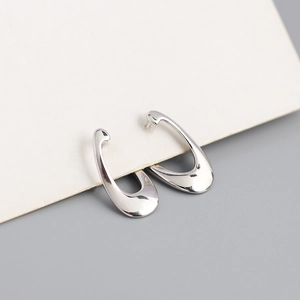 Detailed view of U-shaped S925 silver earrings with mirror polished metallic surface