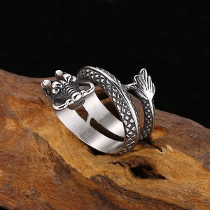 Macro shot of retro stainless steel dragon ring showing detailed scales and punk textures