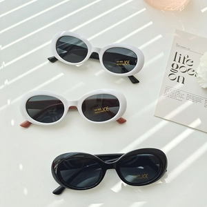 Retro oval kids sunglasses with UV400 protection in white and black frames