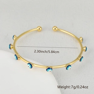 Detail showing dimensions of golden evil eye bangle with blue enamel charms