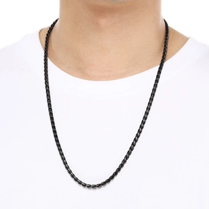 Close-up of a black 18k vacuum plated stainless steel curb chain necklace on male model