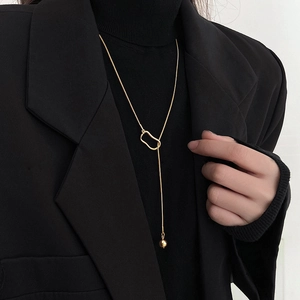 Minimalist gold long sweater necklace with geometric hollow links and polished bead pendant