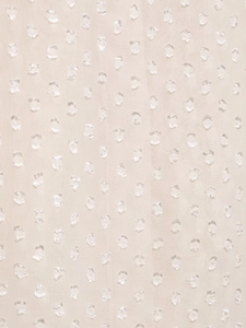Nahaufnahme von beige Tüllstoff mit strukturierten 3D-Jacquard-Punkten-Details