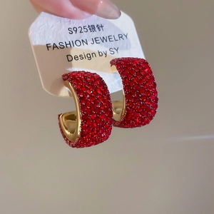 Close-up of C-shaped earrings with red rhinestones and S925 silver needles