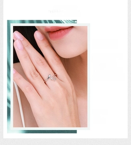 Close-up of minimalist silver snake ring with adjustable open band on model's finger