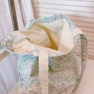 Detailed interior of floral cotton tote bag showing inner pocket and lining