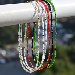 Close-up of colorful crystal beaded necklaces set with gold-plated lobster clasps