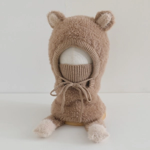 Close-up of plush brown bear ear hat with integrated neck warmer and knit texture