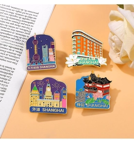 Detail of colorful Shanghai landmark enamel pins showing Oriental Pearl and Wukang Building