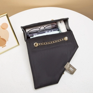 Fashionable black quilted crossbody bag with gold chain strap and spacious interior