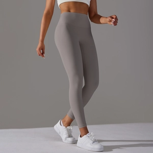Detail of high waisted grey yoga leggings with body contouring seams and elastic fabric