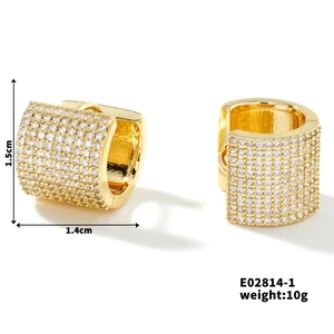 Close-up of 18K gold micro-pave hoop earrings with cubic zirconia, 1.5cm high