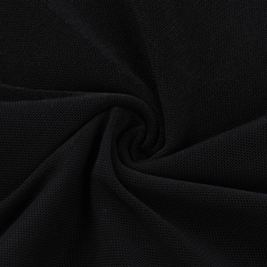 Macro detail of black honeycomb knit mesh fabric texture with spiral pleats