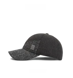 Detail view of the patchwork fabric and leather brand patch on a grey winter earflap hat