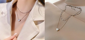 Detail of double-layer titanium steel necklace with solid heart pendant and hollow links