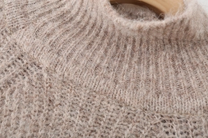 Detail of soft alpaca knit sweater featuring ribbed high neck and fuzzy texture
