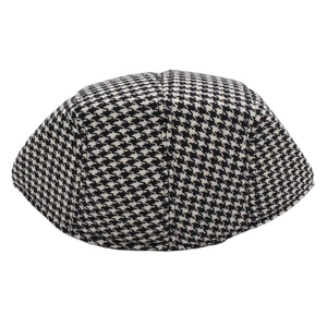 Close-up of the woven houndstooth pattern and stitching on a vintage flat cap