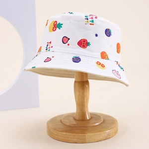 Detail of white canvas kids bucket hat with colorful fruit print and neat brim stitching