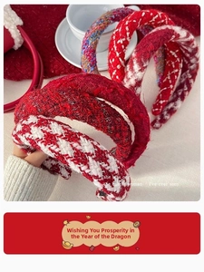 Close-up of red and white houndstooth tweed headband with textured winter fabric detail