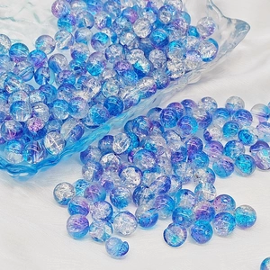 Macro shot of 6mm and 8mm blue and purple cracked glass beads for DIY jewelry making
