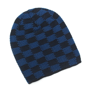 Detail of blue and black checkered knit pattern on a warm winter beanie hat