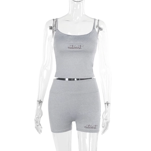 Detail of grey knitted two-piece set featuring square neck top and high-waist shorts
