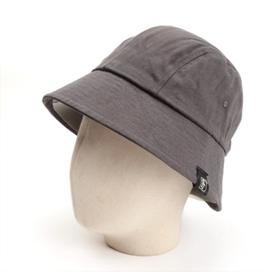 Detail of dark grey cotton bucket hat featuring a woven letter label and side vent holes