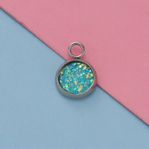Macro shot of 12mm stainless steel pendant tray with shimmering blue-green resin opal inlay