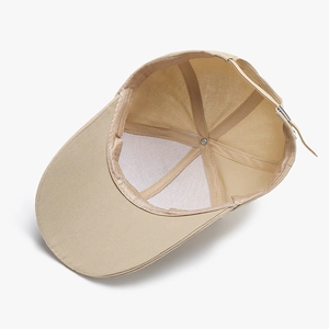 Khaki baseball cap interior view showing fine stitching and adjustable rear strap