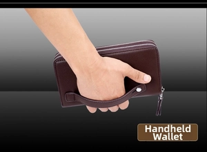 Detail of man holding large capacity double zipper brown leather clutch with wrist strap