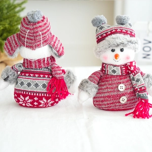 Detail of knit fabric and faux fur texture on red and grey Christmas snowman figurines