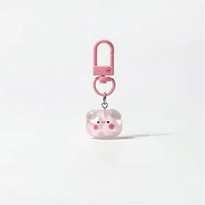 Close-up of pink pig resin charm with matching lobster clasp for bags and keys