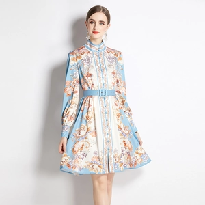 Elegant light blue floral print midi dress with long sleeves and a matching waist belt