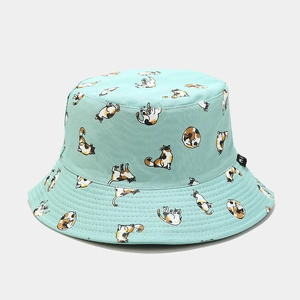 Detail of mint green bucket hat featuring all-over cute cartoon cat prints and fabric texture