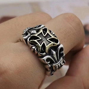 Macro view of vintage silver ring with golden Iron Cross and honeycomb texture