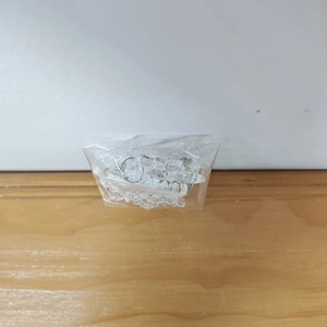 Bulk pack of clear acrylic hexagonal snowflake ornaments in a plastic polybag