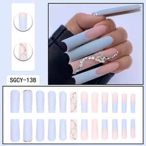 Long coffin fake nails in light blue and nude pink with butterfly and rhinestone accents