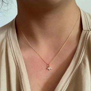 Elegant gold S925 sterling silver necklace with three marquise-cut white gems on a model