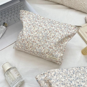 Detailed close-up of corduroy floral makeup bag with elegant Sozakka brand woven label